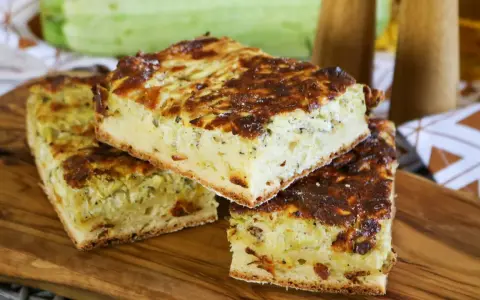 Herzhafte Zucchinikuchen-Stücke auf Holzbrett. Ein köstliches Rezept mit Zucchini, das perfekt für jede Mahlzeit ist.