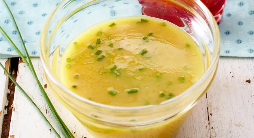 Gelbe Vinaigrette mit Schnittlauch in einer Glasschale, perfekt für frische Salat-Dressing-Ideen.
